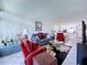 Bright living room with comfortable seating, decorative plants, and an open layout flowing into the kitchen at 1526 Mission Hills Blvd # 18B, Clearwater, FL 33759