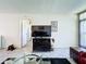 Neutral tile flooring and modern television cabinet for entertainment in this comfortable living room setting at 1526 Mission Hills Blvd # 18B, Clearwater, FL 33759
