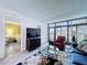 Comfortable living room area with neutral tile flooring, plush seating, and a bright bedroom space visible at 1526 Mission Hills Blvd # 18B, Clearwater, FL 33759