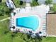 Aerial view of pool featuring sun loungers and a secure fenced perimeter at 1526 Mission Hills Blvd # 18B, Clearwater, FL 33759