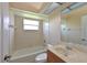 Well-lit bathroom with a combined tub and shower, with tile, plus a vanity with sink at 15518 29Th E St, Parrish, FL 34219