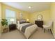 Comfortable bedroom with large window, neutral decor and ensuite bathroom access at 15518 29Th E St, Parrish, FL 34219