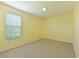 Basic bedroom with yellow walls, a window, and carpet flooring at 15518 29Th E St, Parrish, FL 34219