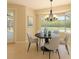 Cozy dining area with a round table and bay window, offering a view of the screened-in pool at 15518 29Th E St, Parrish, FL 34219