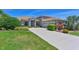 Beautiful single-Gathering home featuring a large front yard and patterned concrete driveway at 15518 29Th E St, Parrish, FL 34219
