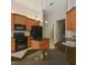 A modern kitchen with wood cabinets, granite countertops and stainless steel appliances, perfect for cooking and entertaining at 15518 29Th E St, Parrish, FL 34219