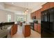 Well-equipped kitchen with stainless steel appliances and wooden cabinetry, adjoining the dining space at 15518 29Th E St, Parrish, FL 34219