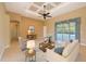 Stylish living room featuring elegant furniture, a ceiling fan, and sliding doors to the pool at 15518 29Th E St, Parrish, FL 34219