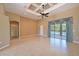Large, open living room with high ceilings, tiled floors, and access to the outdoor pool area at 15518 29Th E St, Parrish, FL 34219