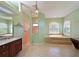 Elegant main bathroom with a soaking tub, a separate shower, and dual vanities at 15518 29Th E St, Parrish, FL 34219