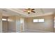 Spacious main bedroom featuring a tray ceiling with fan and ensuite bathroom at 15518 29Th E St, Parrish, FL 34219