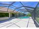Spacious screened patio with a sparkling pool, offering ample space for outdoor enjoyment at 15518 29Th E St, Parrish, FL 34219