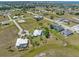 Expansive aerial view of a neighborhood featuring well-manicured lawns, pools, and waterfront access at 17343 Cayo Ln, Punta Gorda, FL 33955