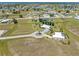 Wide aerial shot of homes in a residential neighborhood with canals, roads, and lush green lawns at 17343 Cayo Ln, Punta Gorda, FL 33955