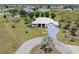 Stunning aerial view of a home with a circular driveway and lush green landscaping in a quiet neighborhood at 17343 Cayo Ln, Punta Gorda, FL 33955