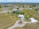 Expansive aerial view of a neighborhood featuring single-Gathering homes, green lawns, and distant lakes at 17343 Cayo Ln, Punta Gorda, FL 33955