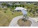 Aerial view of a single-story home with a circular driveway and mature landscaping at 17343 Cayo Ln, Punta Gorda, FL 33955