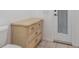 Bathroom features a toilet and a wicker cabinet near a door to the outside at 17343 Cayo Ln, Punta Gorda, FL 33955