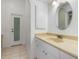 Bathroom featuring cream countertop, an oval mirror, and door to outside at 17343 Cayo Ln, Punta Gorda, FL 33955