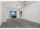 Bright bedroom featuring plush carpet and sliding glass doors to the lanai and pool at 17343 Cayo Ln, Punta Gorda, FL 33955
