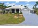 Beautiful one-story home with a well-manicured lawn and an attached garage at 17343 Cayo Ln, Punta Gorda, FL 33955