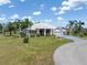 Beautiful single-story home with lush landscaping and a well-manicured lawn at 17343 Cayo Ln, Punta Gorda, FL 33955
