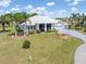 Beautiful single-story home with a well-manicured lawn and mature palm trees at 17343 Cayo Ln, Punta Gorda, FL 33955