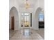 Inviting foyer with decorative tile, arched doorways and a stylish light fixture at 17343 Cayo Ln, Punta Gorda, FL 33955