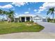 Inviting single-story home with a well-kept lawn, beautiful landscaping, and a spacious driveway at 17343 Cayo Ln, Punta Gorda, FL 33955