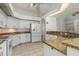 Modern kitchen boasts granite countertops, white cabinets, stainless appliances, and tile floors at 17343 Cayo Ln, Punta Gorda, FL 33955