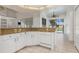 Bright kitchen features granite countertops, white cabinetry, and an adjacent breakfast nook with pool view at 17343 Cayo Ln, Punta Gorda, FL 33955