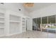 Living space with built-in shelves and sliding doors leading to the pool area at 17343 Cayo Ln, Punta Gorda, FL 33955