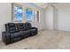 Spacious living room with plush carpet, large windows, and a modern ceiling fan at 17343 Cayo Ln, Punta Gorda, FL 33955