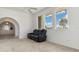 Bright living room with carpet, large windows with view, and arched doorway to dining area at 17343 Cayo Ln, Punta Gorda, FL 33955