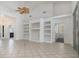 Large living room with built-in shelves, neutral tile floor and fan at 17343 Cayo Ln, Punta Gorda, FL 33955