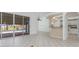 Open-concept living space with tile floors, bar seating, and access to the kitchen at 17343 Cayo Ln, Punta Gorda, FL 33955