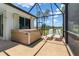 Covered patio features a hot tub and lounge chairs at 17343 Cayo Ln, Punta Gorda, FL 33955