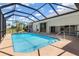 A screened-in pool offers a private and relaxing outdoor space next to the house at 17343 Cayo Ln, Punta Gorda, FL 33955