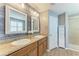 Bathroom features a double sink vanity, wood-look plank accent wall, granite counters and tiled floor at 2084 La Palma Ave, Port Charlotte, FL 33953