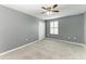 Neutral bedroom features a ceiling fan, a window with white shutters, and a closet with bi-fold doors at 2084 La Palma Ave, Port Charlotte, FL 33953