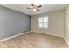 Bright bedroom with wood-style tile flooring, fan, window with shutters and neutral walls at 2084 La Palma Ave, Port Charlotte, FL 33953