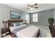 Staged primary bedroom with ceiling fan, shutters, mounted TV and contemporary decor at 2084 La Palma Ave, Port Charlotte, FL 33953