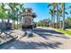 Gated community entrance surrounded by lush palm trees and landscaping at 2084 La Palma Ave, Port Charlotte, FL 33953