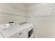 Laundry area with washer, dryer, and wire shelving at 2084 La Palma Ave, Port Charlotte, FL 33953