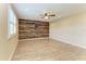 Living room featuring wood-look tile flooring, a ceiling fan, and decorative wood accent wall at 2084 La Palma Ave, Port Charlotte, FL 33953