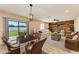Living room with dining area, stylish furniture, wood accent wall, and sliding glass door to the backyard at 2084 La Palma Ave, Port Charlotte, FL 33953