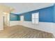 Spacious living room with wood floors, wainscoting, and white trim at 2084 La Palma Ave, Port Charlotte, FL 33953
