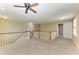 Bright, open loft space with multiple windows, railing, ceiling fan and carpeted floor at 2084 La Palma Ave, Port Charlotte, FL 33953