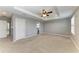 Spacious main bedroom with carpet, tray ceiling, neutral paint and attached bathroom entrance at 2084 La Palma Ave, Port Charlotte, FL 33953