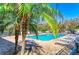 Beautiful community pool area with palm trees and plenty of lounge chairs for relaxing in the sun at 2084 La Palma Ave, Port Charlotte, FL 33953